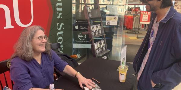 Diane speaking to a student at her book signing