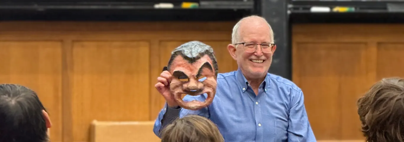 Tim Moore holding a Greek theatre mask