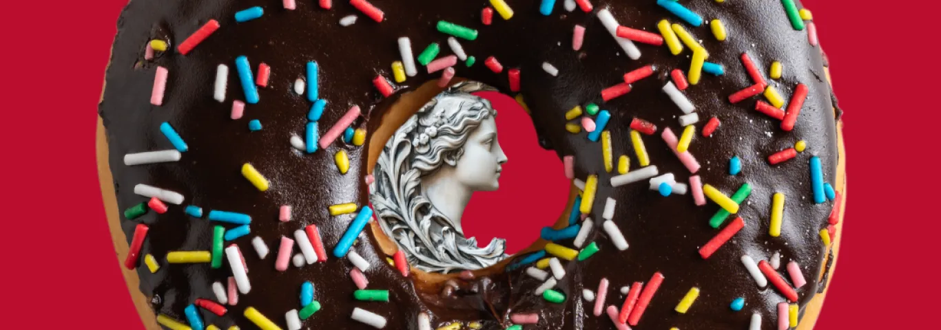 donut with a greek sculpture of a woman's face in the middle