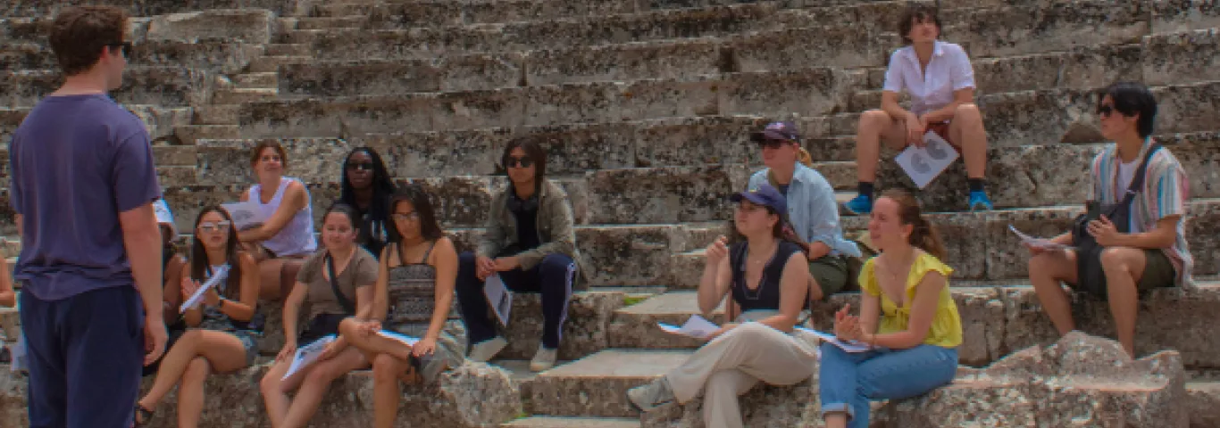 students listening to a speaker in a Roman ampitheatre