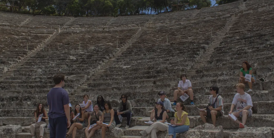 students sitting in a greek ampitheatre