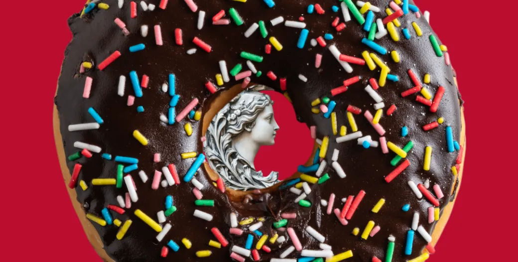 donut with a greek sculpture of a woman's face in the middle
