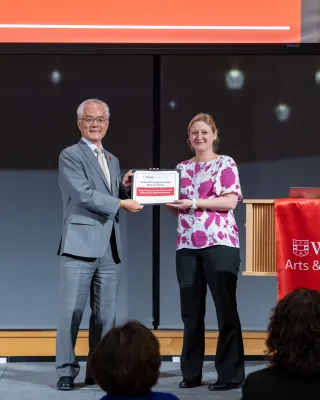 Dean Hu handing Wilson her award certificate
