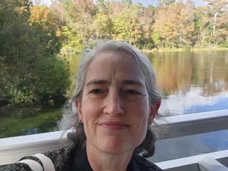 selfie of Keane with a body of water behind her
