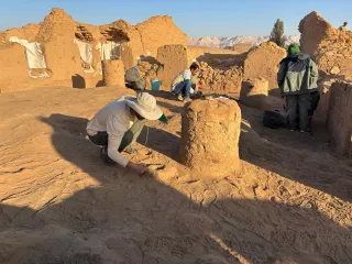 Held Cleaning a post-abandonment feature in Room 7 of building B10 prior to photographing it.  