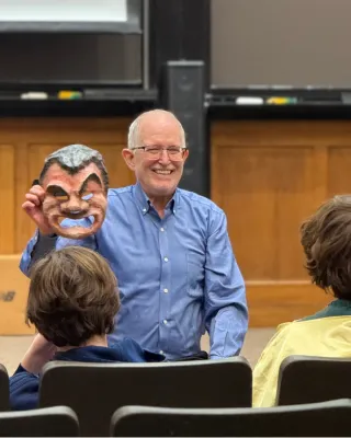 Moore holding a Roman theater mask 