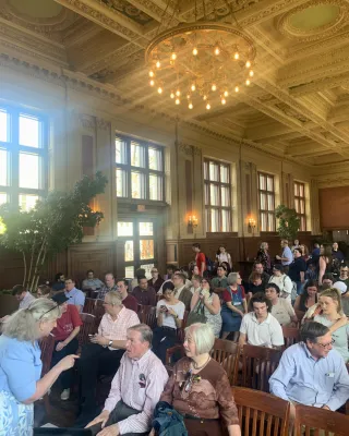Holmes Lounge filled with people gathering for Meyer's lecture