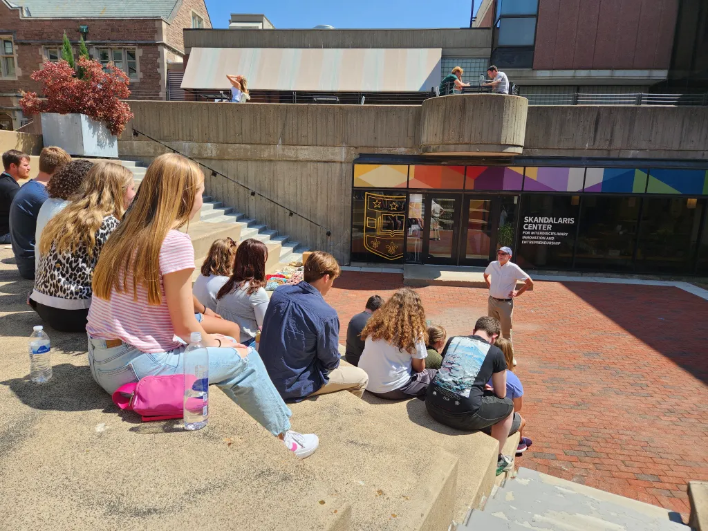 students sitting in a greek-style ampitheatre