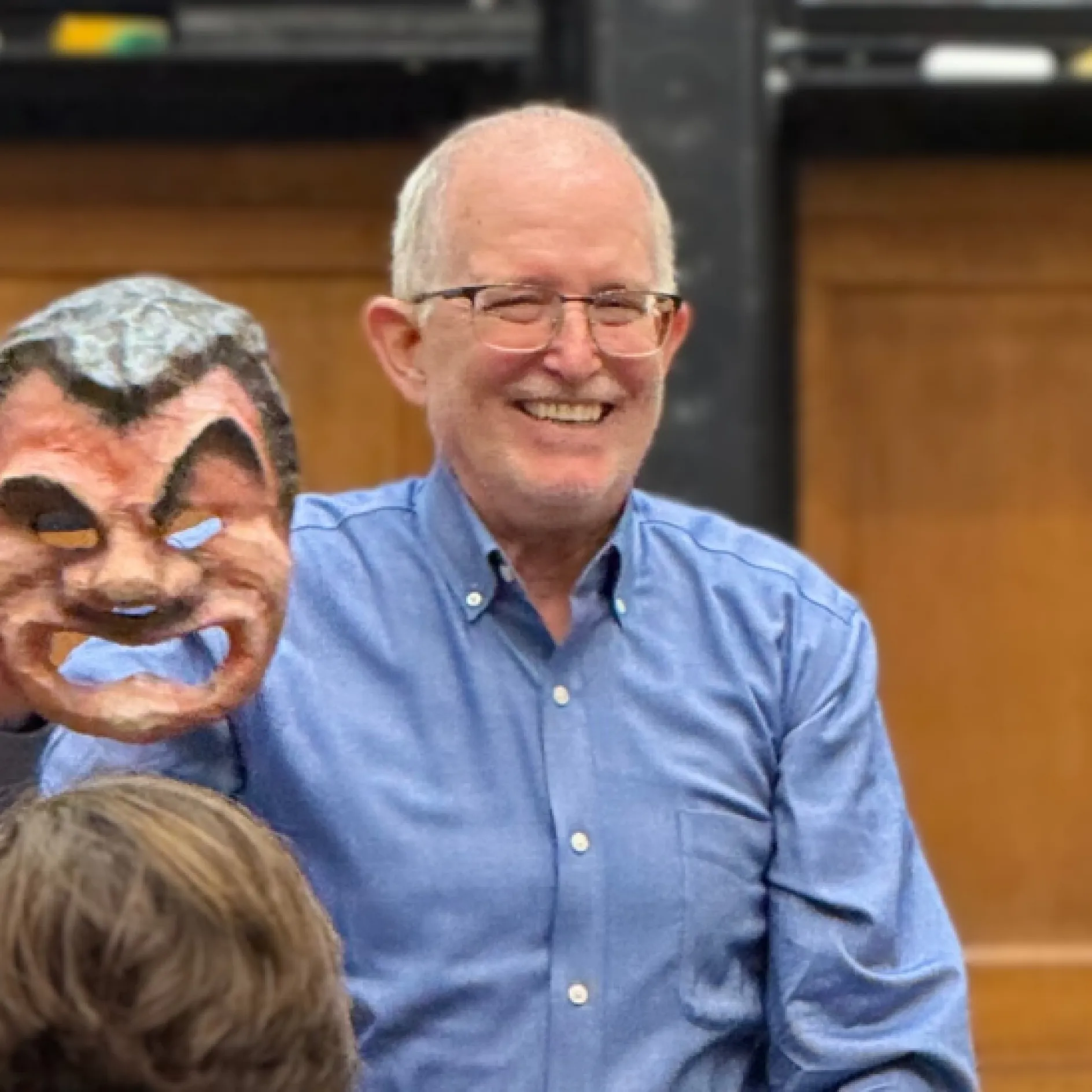 Tim Moore holding a Greek theatre mask