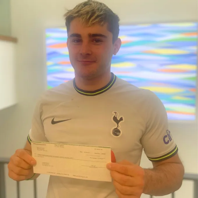 Aaron Held holding a check