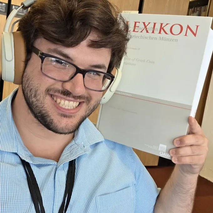 Pawlush holding a book title "Lexikon"
