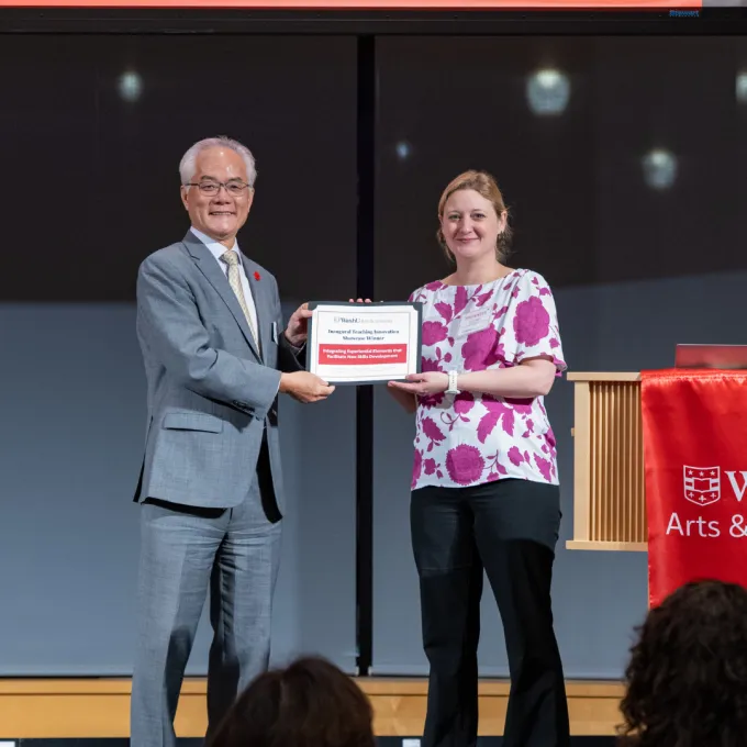 Dean Hu handing Wilson her award certificate